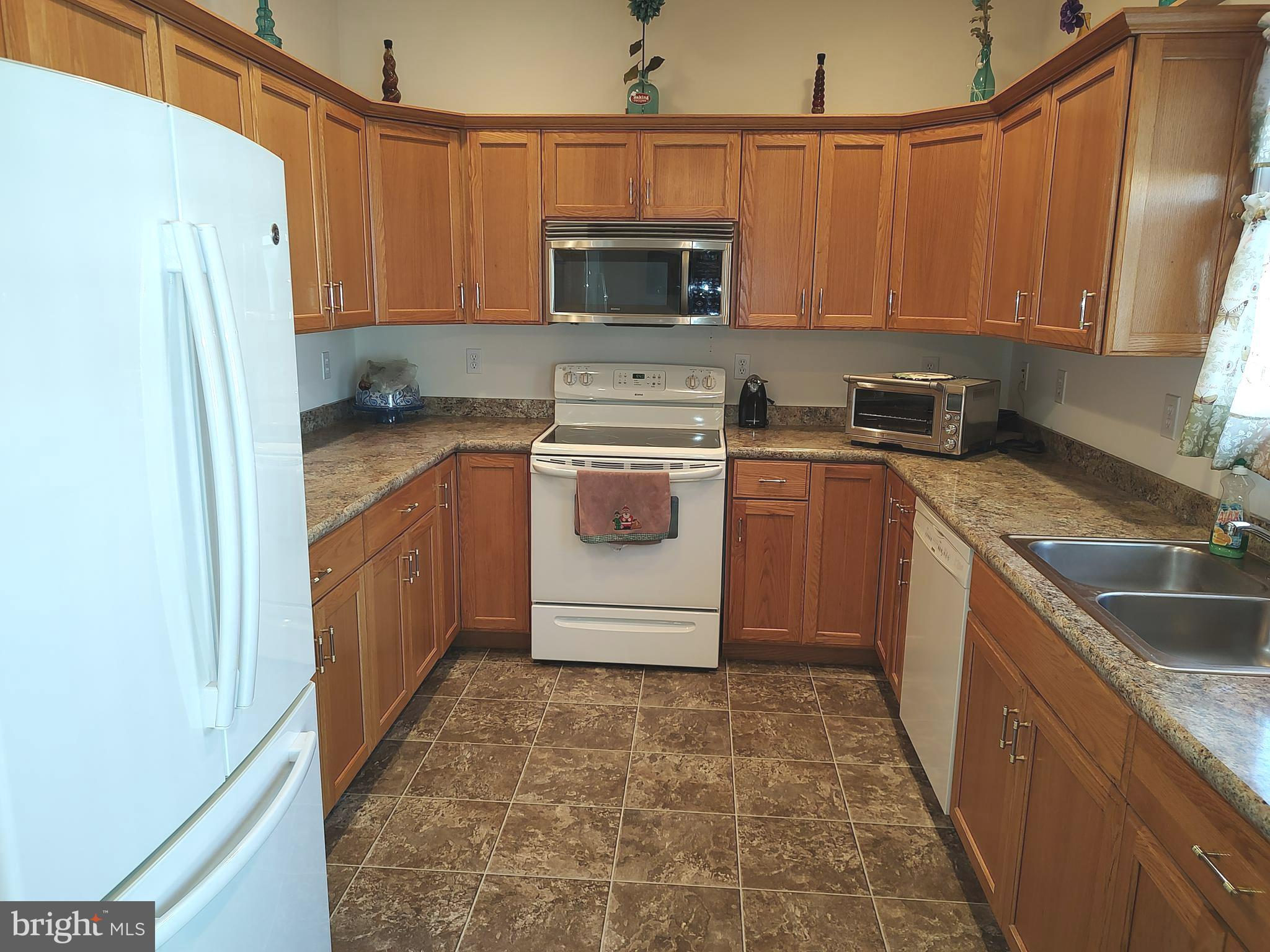2 Castleberry Lane Georgetown, DE 19947 - Photo 18 of 46 a kitchen with a stove sink and microwave