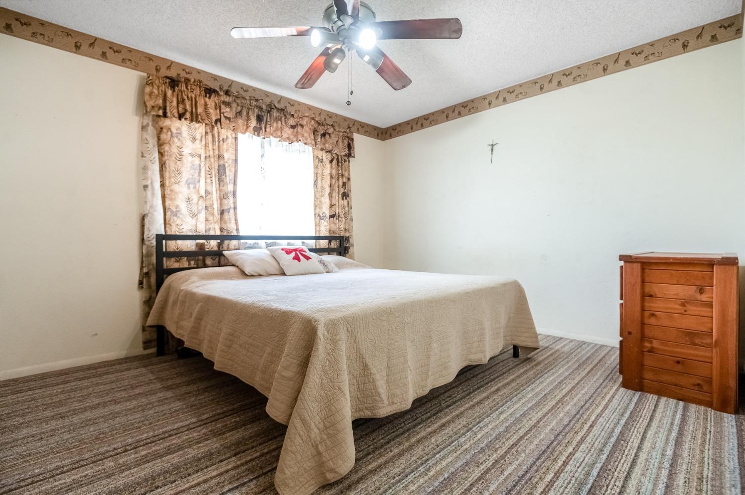 4306 Avenue 50 Alpaugh, CA 93201 - Photo 19 of 56 a bedroom with a bed and wooden floor