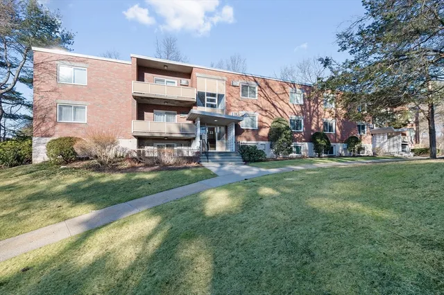 a front view of a building with a yard