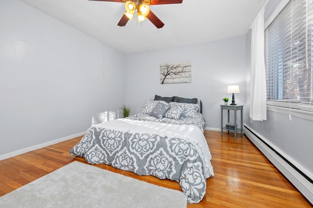 33 Jacqueline Road, Unit D Waltham, MA 02452 - Photo 15 of 26 a bedroom with a bed and wooden floor