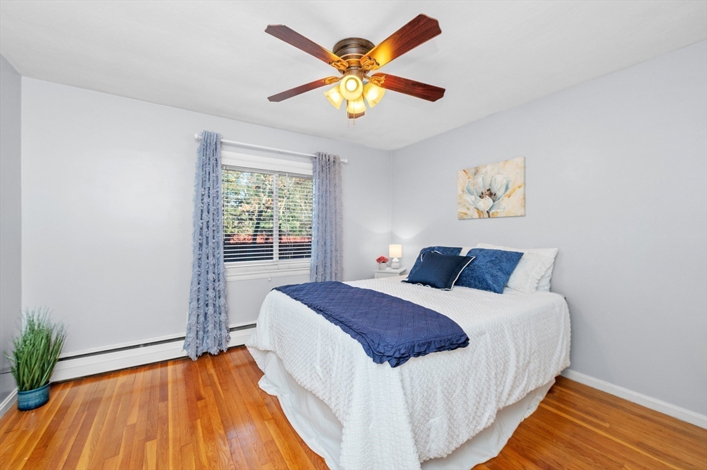 33 Jacqueline Road, Unit D Waltham, MA 02452 - Photo 18 of 26 a bedroom with a bed and painting on the wall