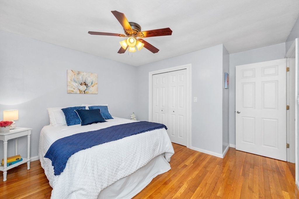 33 Jacqueline Road, Unit D Waltham, MA 02452 - Photo 19 of 26 a bedroom with a bed and a chandelier