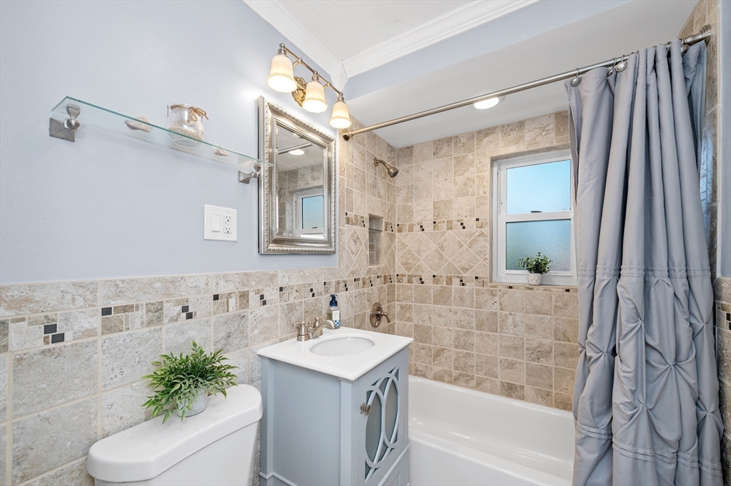 33 Jacqueline Road, Unit D Waltham, MA 02452 - Photo 21 of 26 a bathroom with a granite countertop sink a toilet and shower