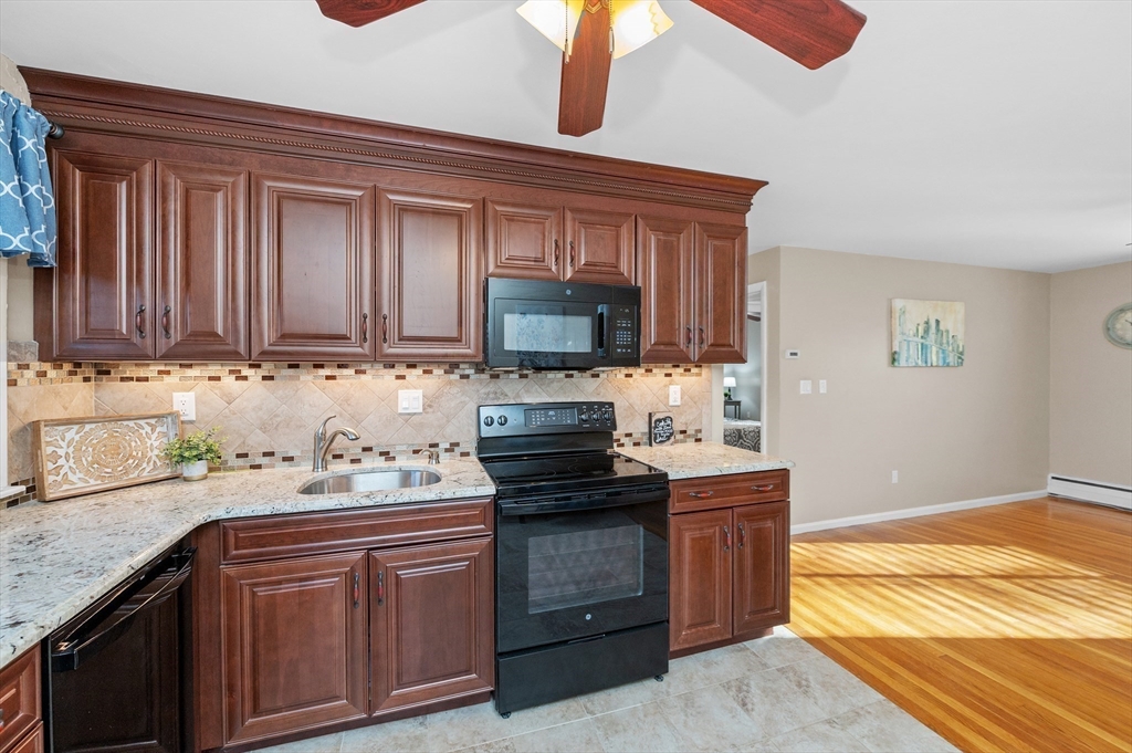 33 Jacqueline Road, Unit D Waltham, MA 02452 - Photo 5 of 26 a kitchen with a sink stove and microwave