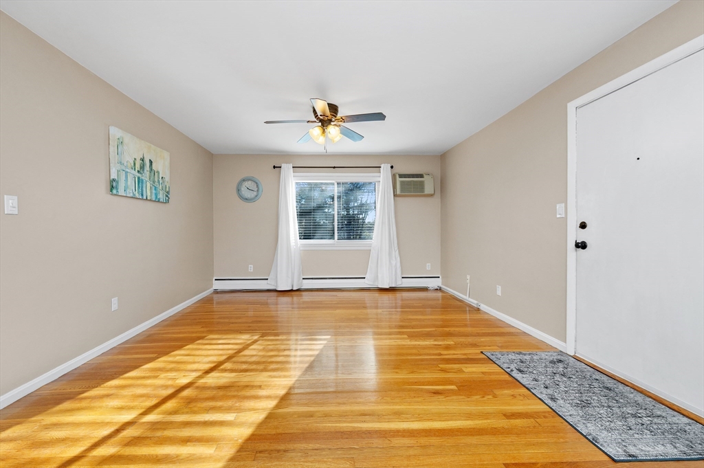 33 Jacqueline Road, Unit D Waltham, MA 02452 - Photo 8 of 26 a view of an empty room with window and wooden floor