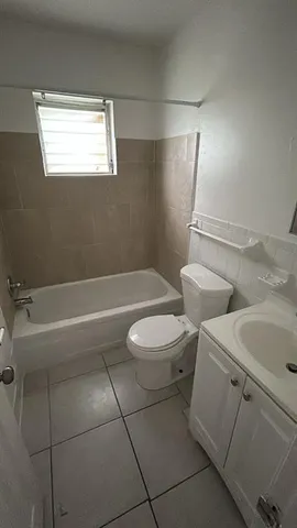 a bathroom with a toilet a sink and bathtub