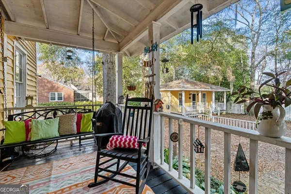 a view of a chairs and table in the balcony