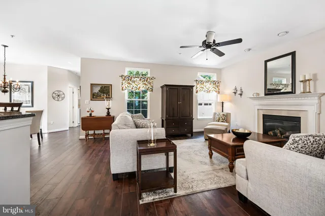 a living room with furniture a fireplace and a window