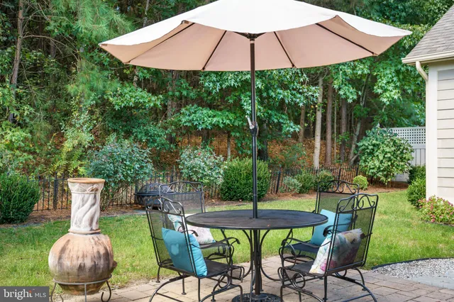 a patio with a table and chairs