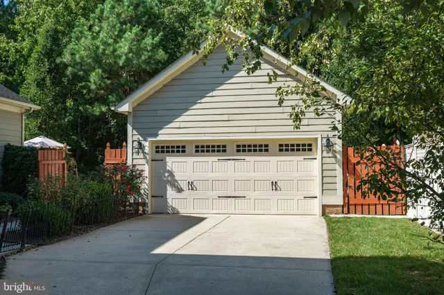 a view of house with outdoor space and trees in the background
