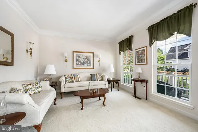 a living room with furniture tv and a floor to ceiling window