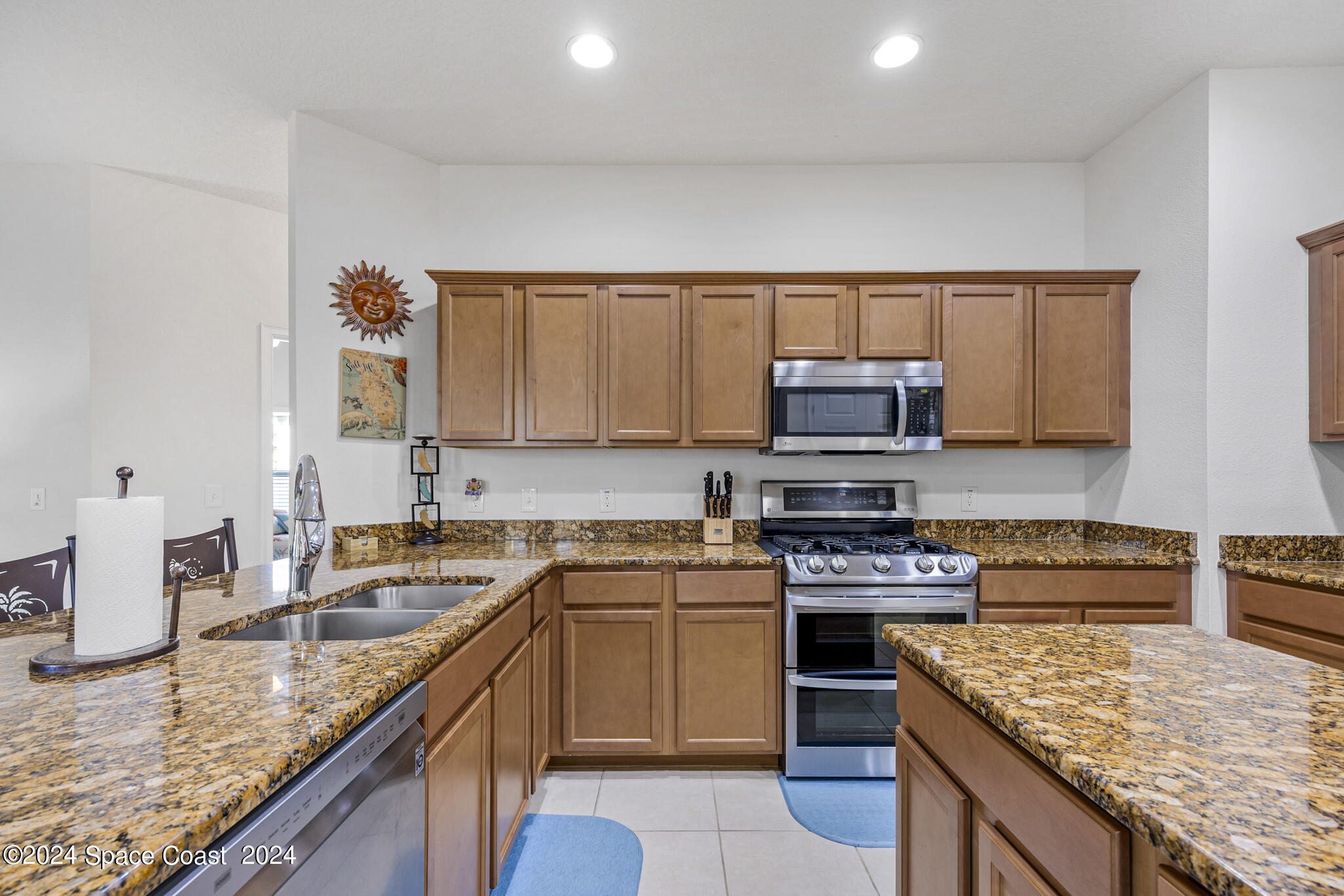 572 Glenbrook Circle Rockledge, FL 32955 - Photo 11 of 35 a kitchen with stainless steel appliances granite countertop a stove top oven a sink a counter space and cabinets