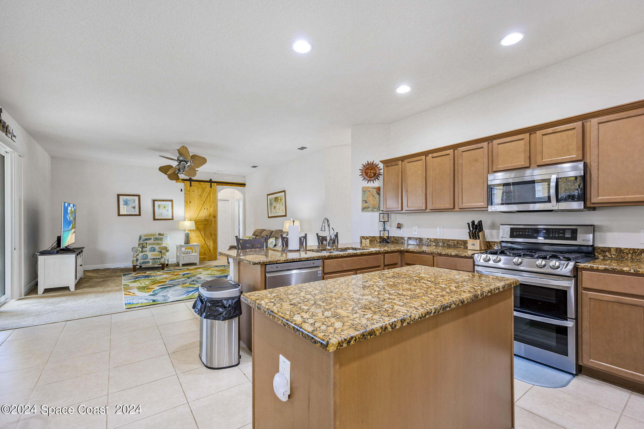 572 Glenbrook Circle Rockledge, FL 32955 - Photo 12 of 35 a kitchen with a stove a sink a refrigerator and cabinets