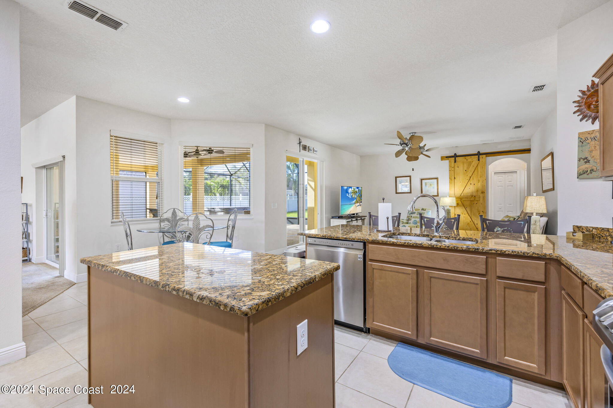 572 Glenbrook Circle Rockledge, FL 32955 - Photo 13 of 35 a kitchen with granite countertop kitchen island sink and center island