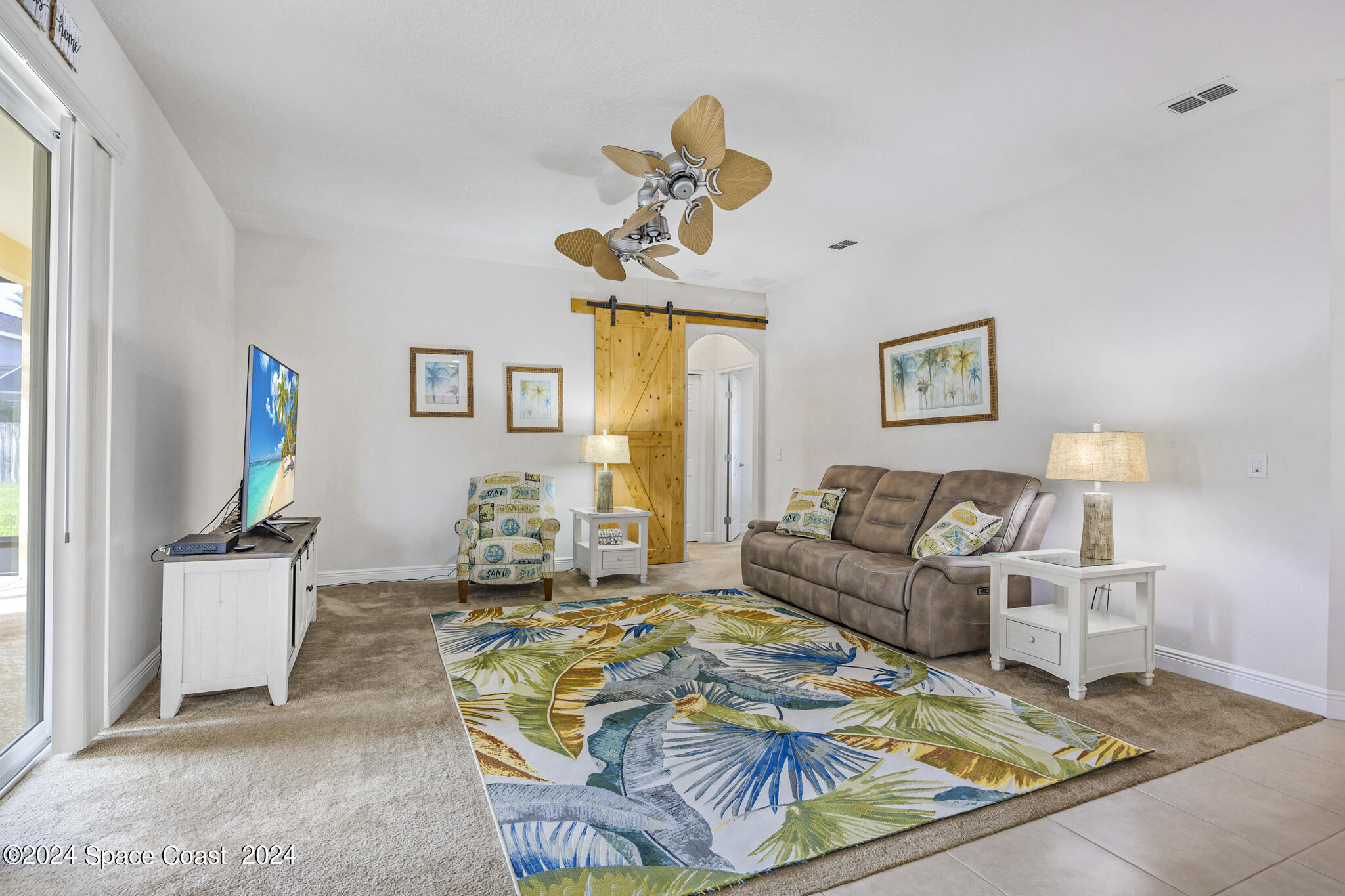 572 Glenbrook Circle Rockledge, FL 32955 - Photo 19 of 35 a living room with patio furniture and a window