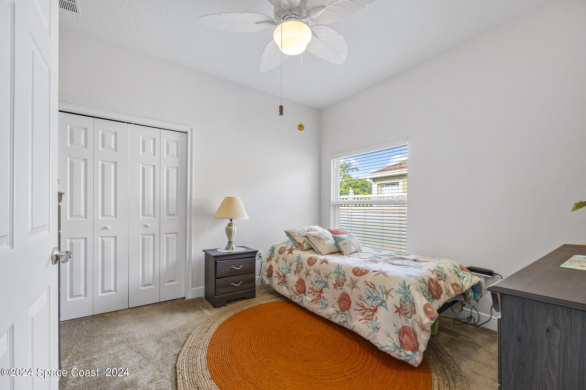 572 Glenbrook Circle Rockledge, FL 32955 - Photo 20 of 35 a bedroom with a bed and a chandelier