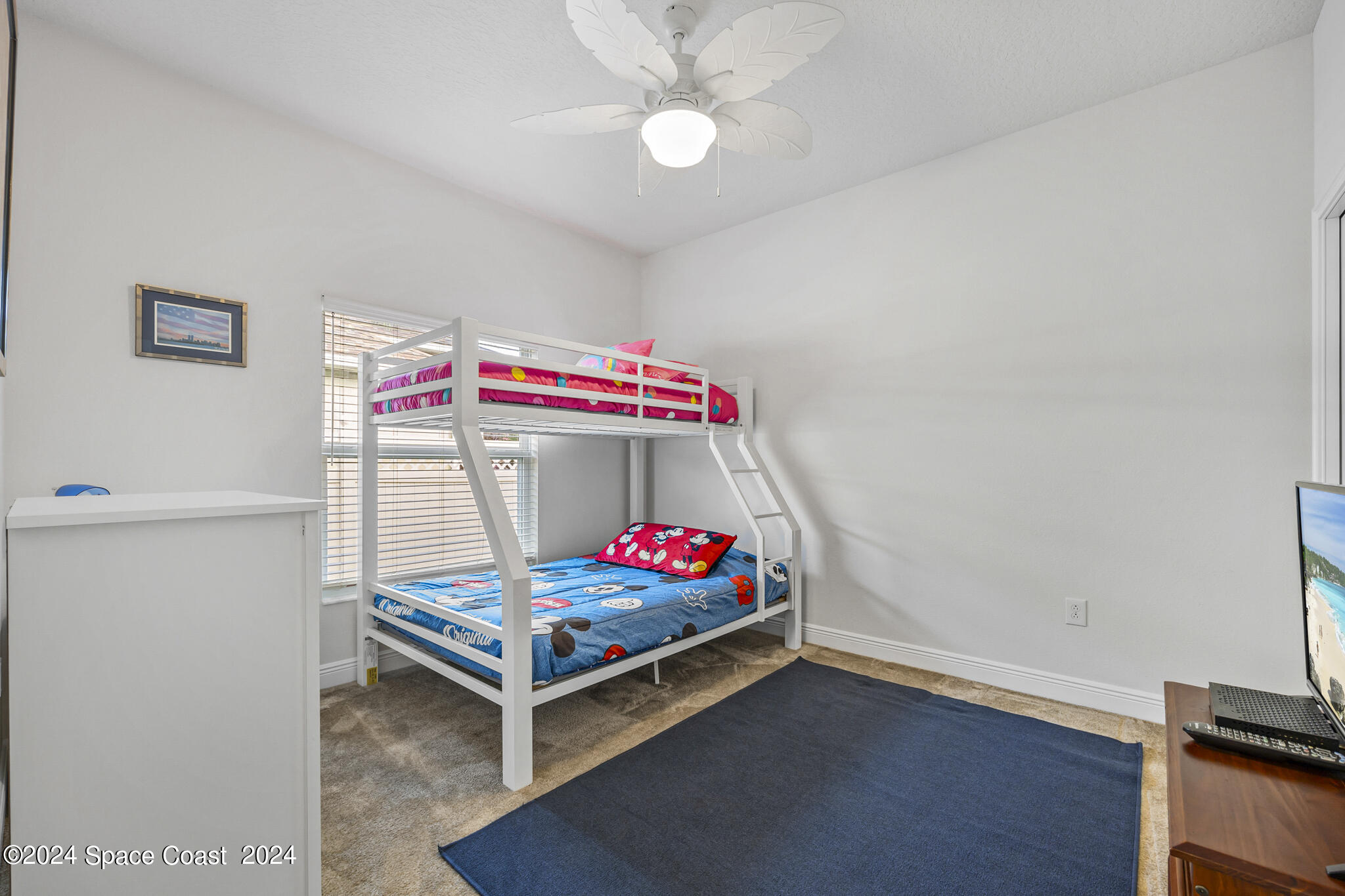 572 Glenbrook Circle Rockledge, FL 32955 - Photo 21 of 35 a bedroom with a bed and a chandelier