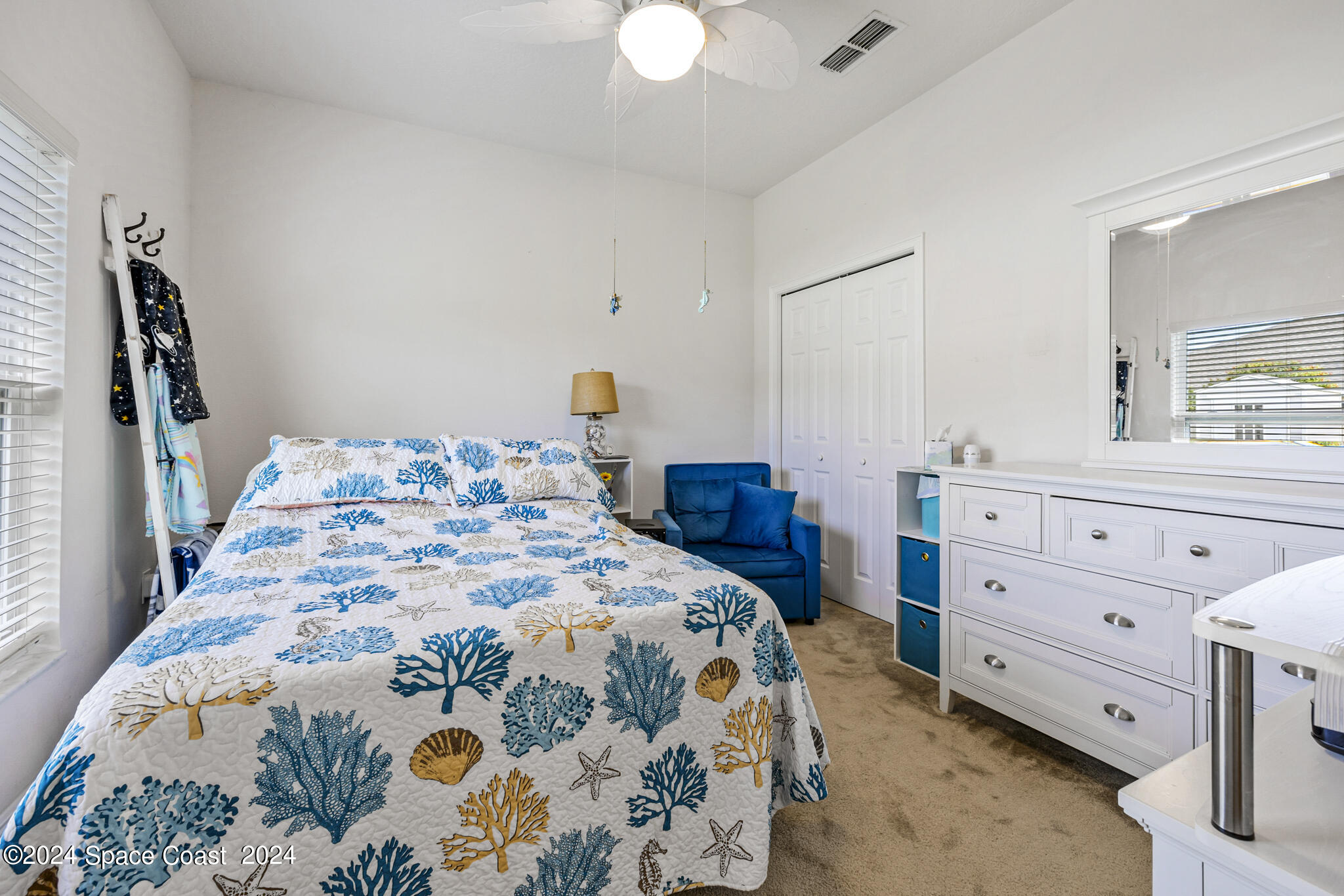 572 Glenbrook Circle Rockledge, FL 32955 - Photo 23 of 35 a bedroom with a bed and a chandelier