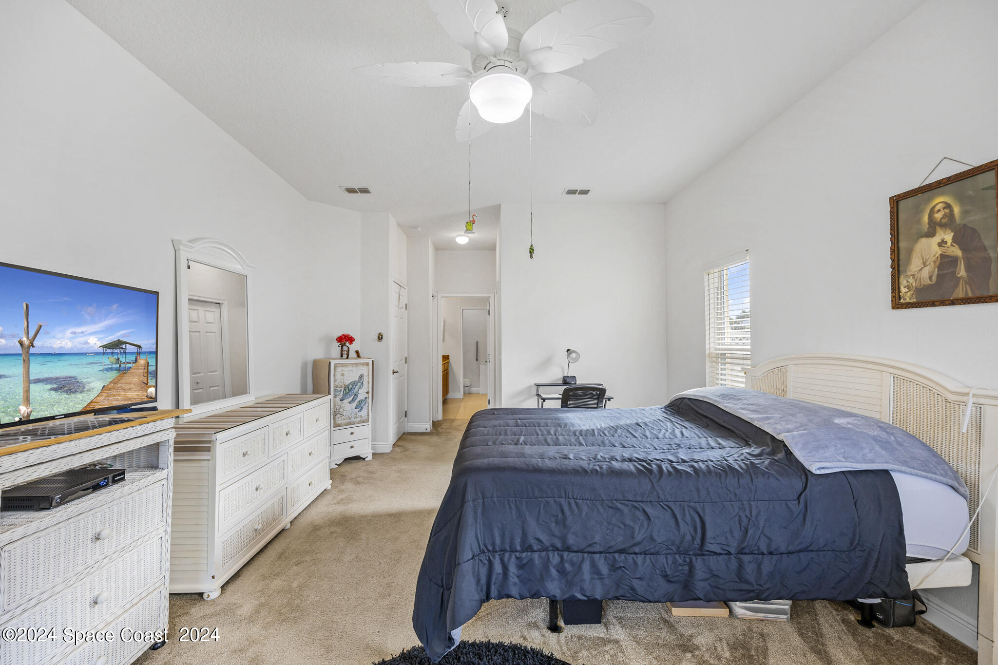 572 Glenbrook Circle Rockledge, FL 32955 - Photo 26 of 35 a spacious bedroom with a bed and a flat screen tv