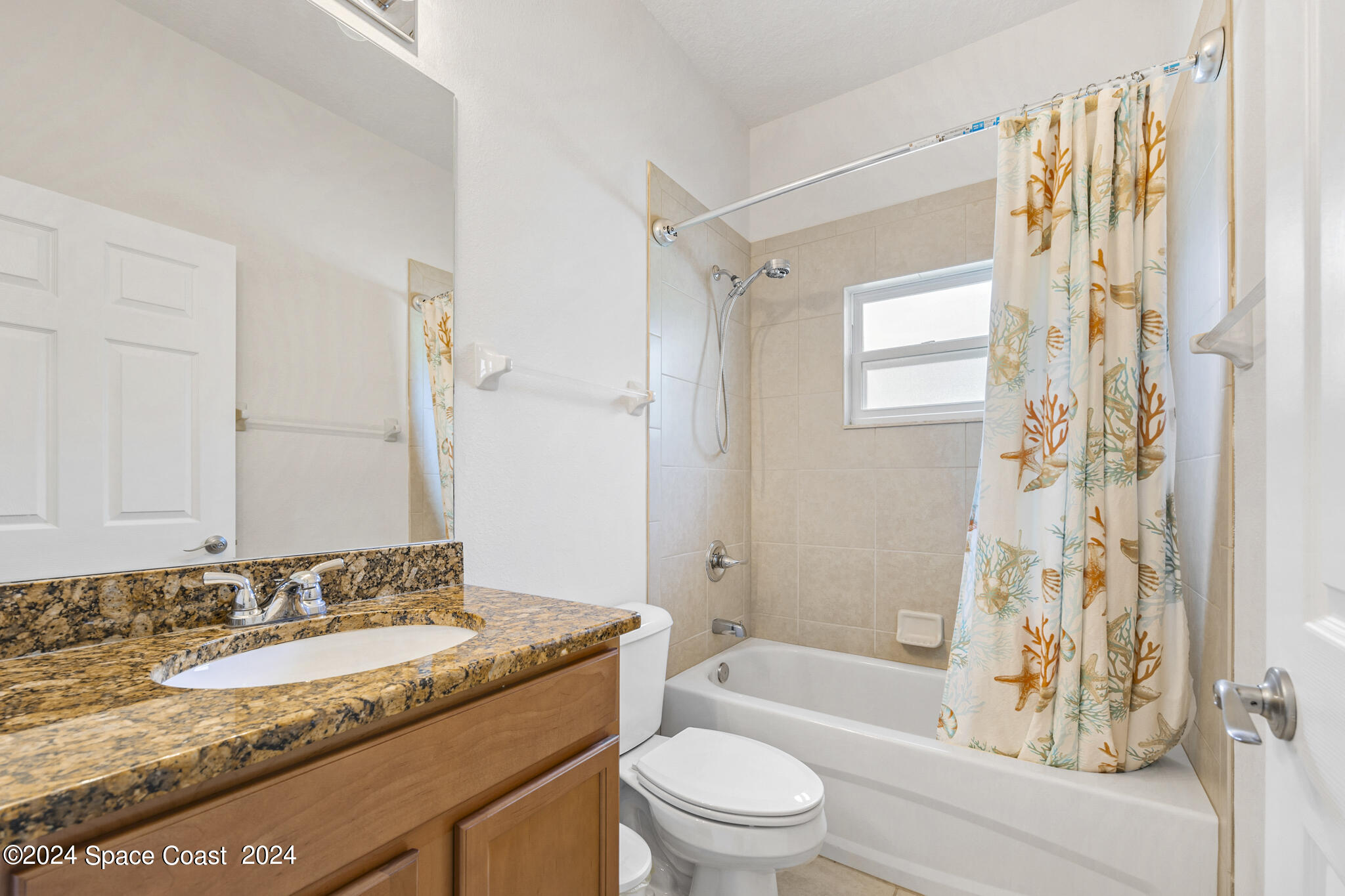 572 Glenbrook Circle Rockledge, FL 32955 - Photo 28 of 35 a bathroom with a granite countertop sink toilet and shower