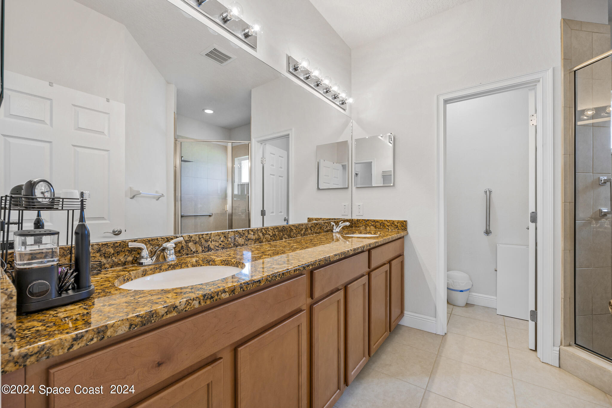572 Glenbrook Circle Rockledge, FL 32955 - Photo 32 of 35 a bathroom with a granite countertop sink and a mirror