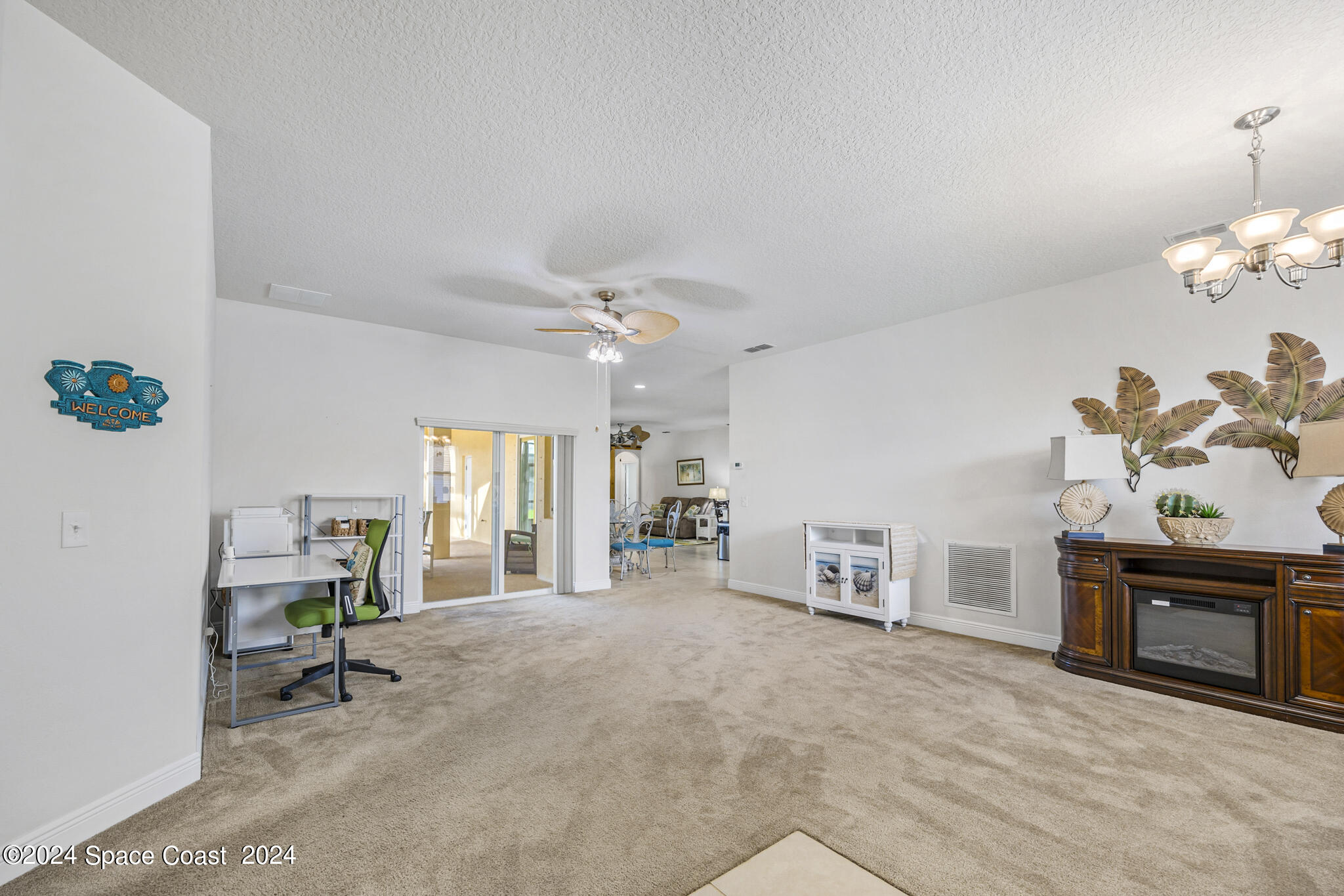 572 Glenbrook Circle Rockledge, FL 32955 - Photo 5 of 35 a view of a livingroom with furniture and a ceiling fan