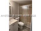 721 North Pine Island Road, Unit 201 Plantation, FL 33324 - Photo 11 of 18 a bathroom with a toilet a sink and mirror