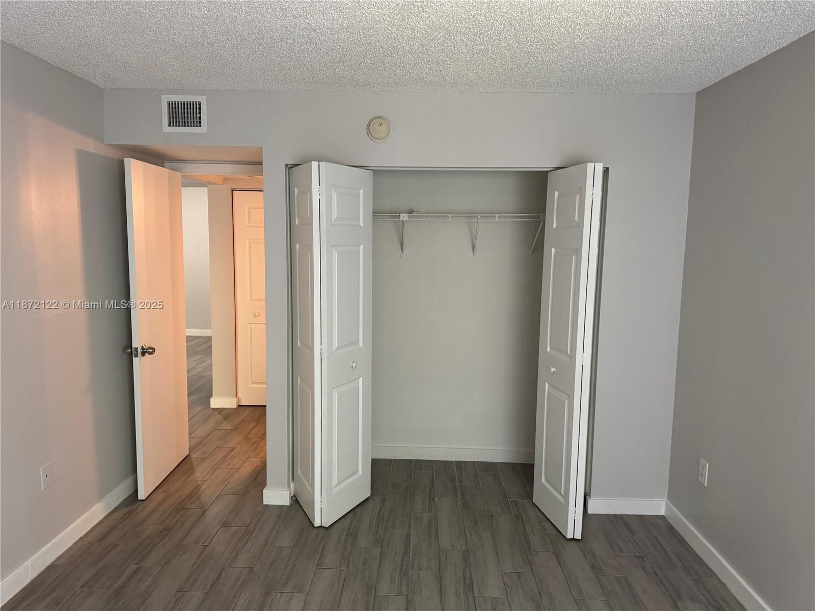 721 North Pine Island Road, Unit 201 Plantation, FL 33324 - Photo 13 of 18 an empty room with wooden floor and a window
