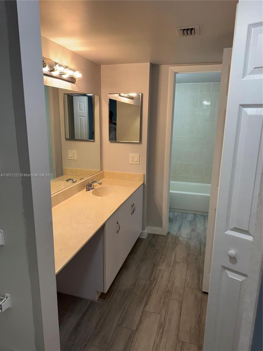 721 North Pine Island Road, Unit 201 Plantation, FL 33324 - Photo 15 of 18 a spacious bathroom with a double vanity sink and a mirror