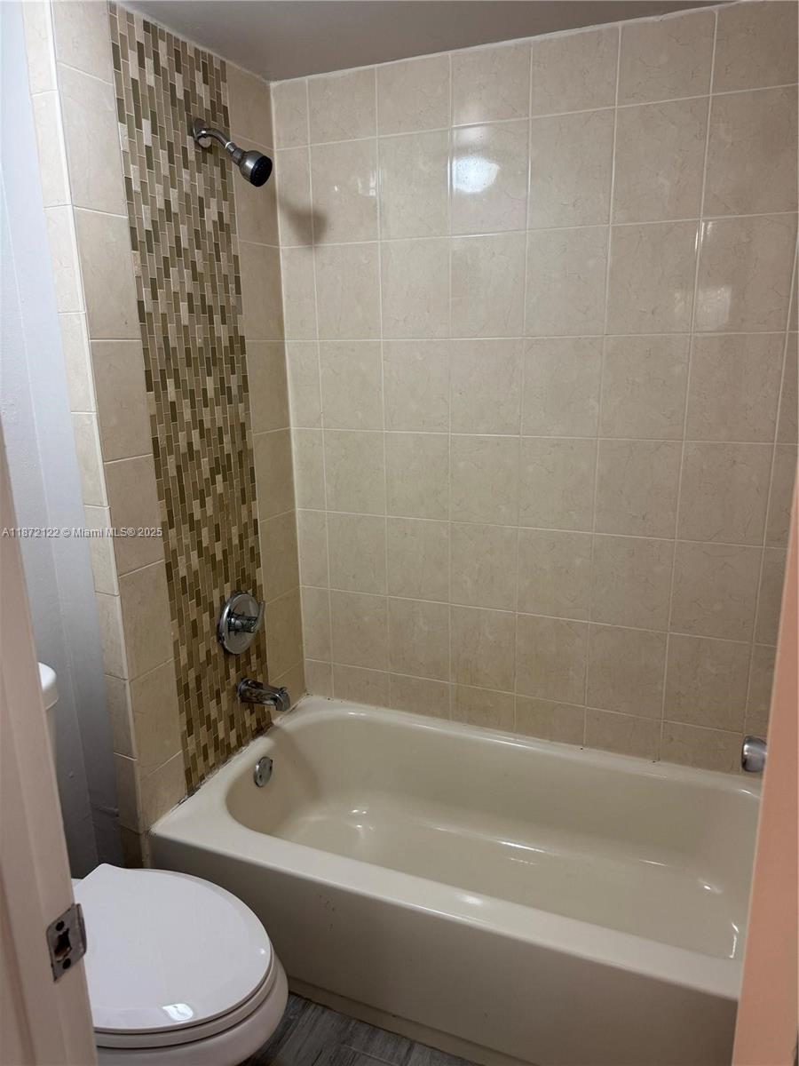 721 North Pine Island Road, Unit 201 Plantation, FL 33324 - Photo 16 of 18 a bathroom with a toilet and shower