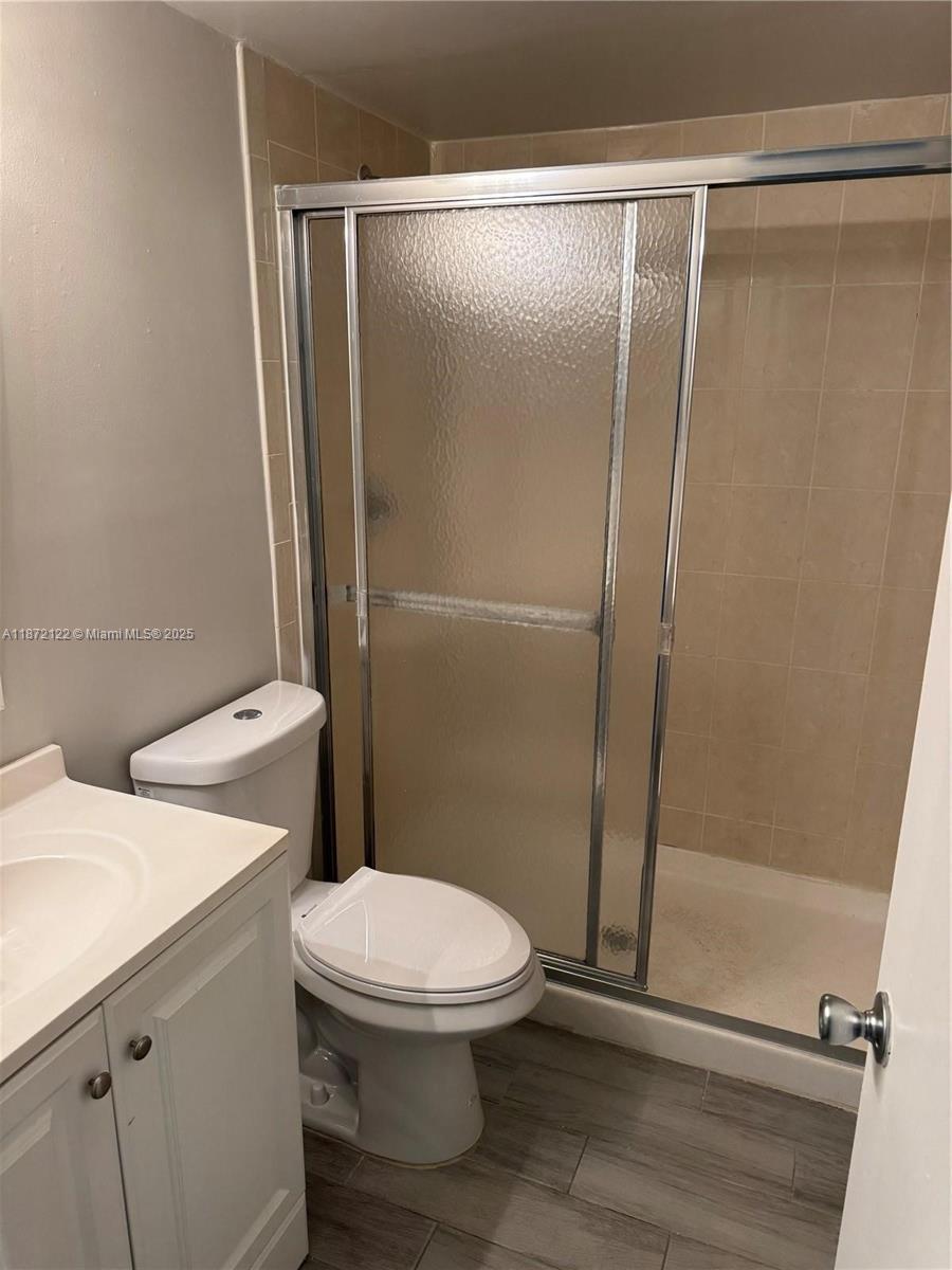 721 North Pine Island Road, Unit 201 Plantation, FL 33324 - Photo 8 of 18 a white toilet sitting next to a shower