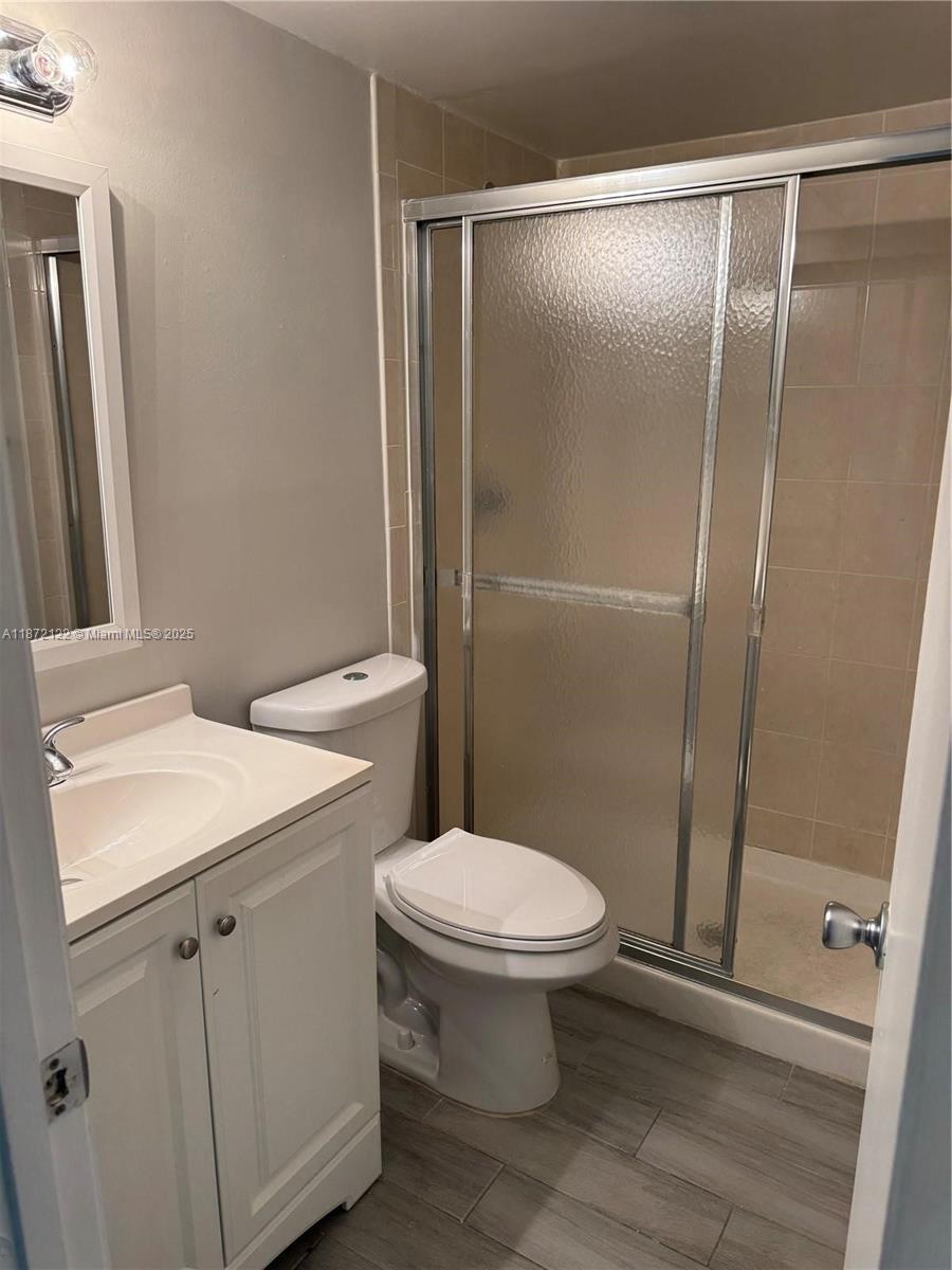 721 North Pine Island Road, Unit 201 Plantation, FL 33324 - Photo 9 of 18 a white toilet sitting next to a bathroom sink