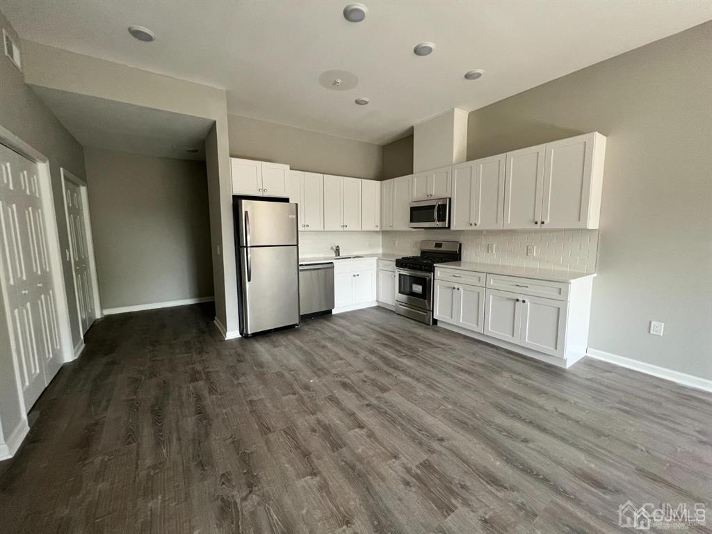 37 Old Trenton Road, Unit 17 Cranbury, NJ 08512 - Photo 1 of 11 a kitchen with a refrigerator a stove top oven a sink and dishwasher with wooden floor