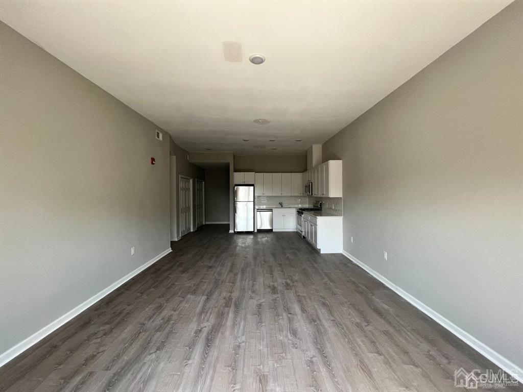 37 Old Trenton Road, Unit 17 Cranbury, NJ 08512 - Photo 2 of 11 a view of empty room with wooden floor