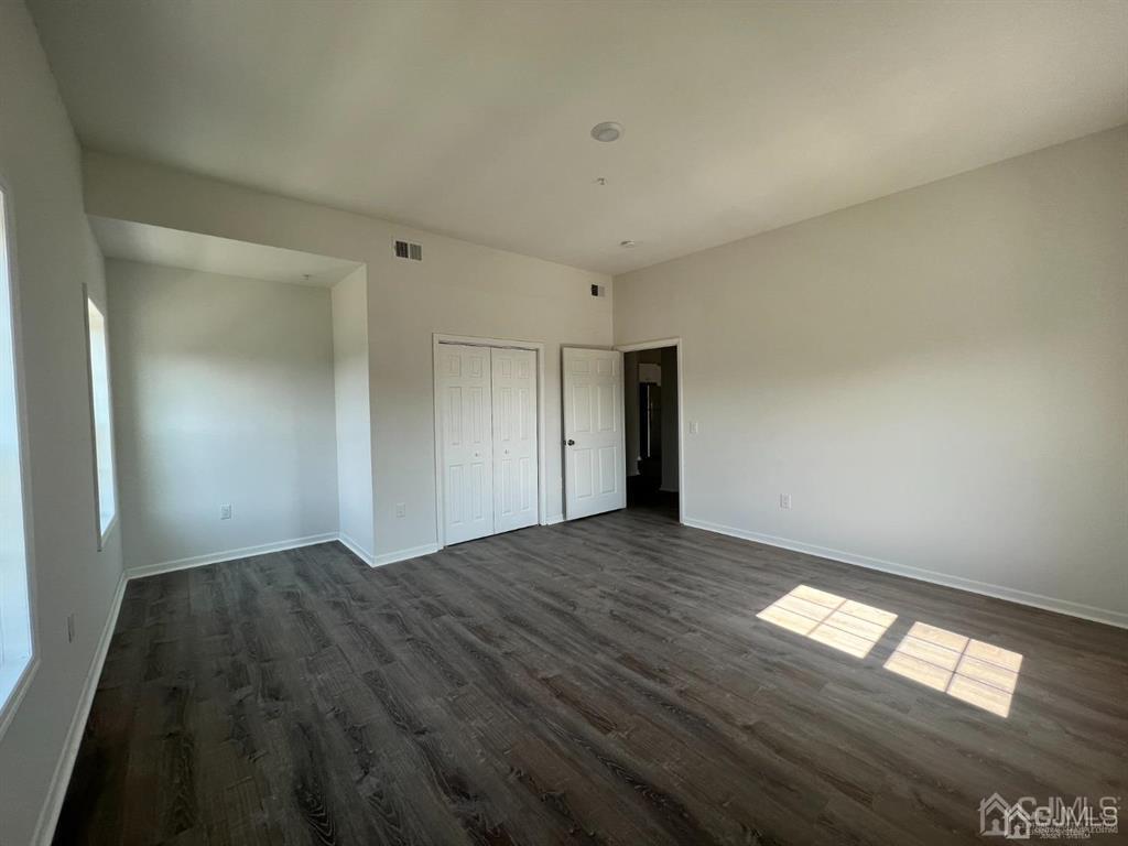 37 Old Trenton Road, Unit 17 Cranbury, NJ 08512 - Photo 5 of 11 a view of empty room with wooden floor and fan