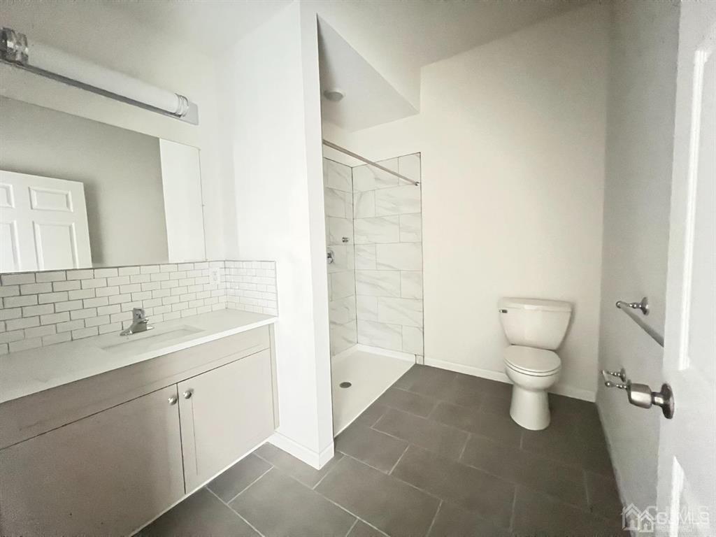 37 Old Trenton Road, Unit 17 Cranbury, NJ 08512 - Photo 8 of 11 a bathroom with a toilet sink and mirror