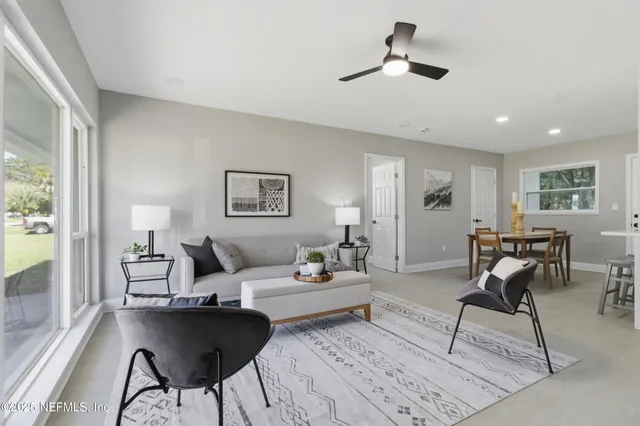 a living room with furniture and a large window