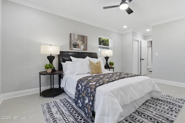 a bedroom with a bed and a lamp with wooden floor