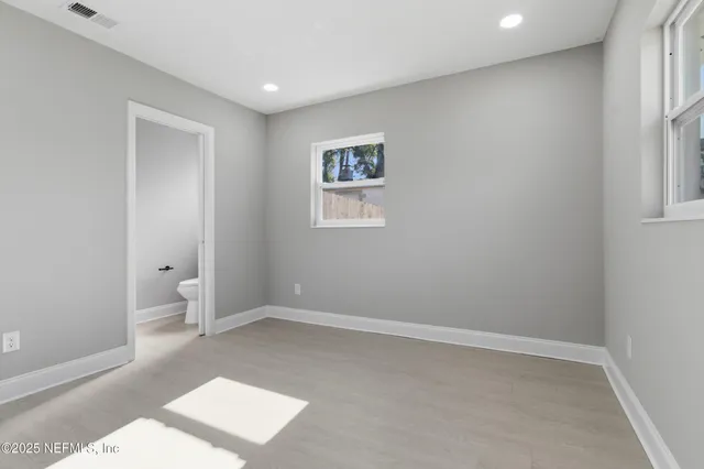 a white toilet sitting next to a window