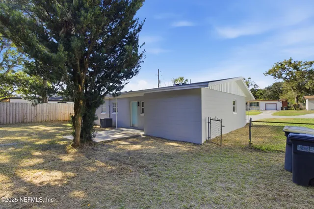 a view of a house with a yard and garage