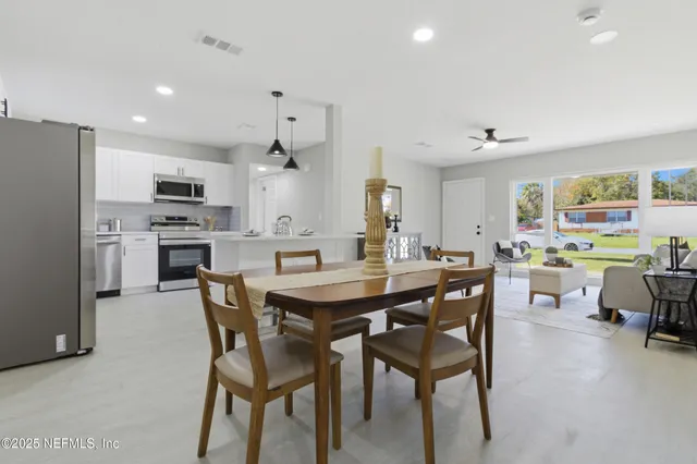 a view of a dining room with furniture and a kitchen