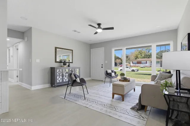 a living room with furniture and a large window