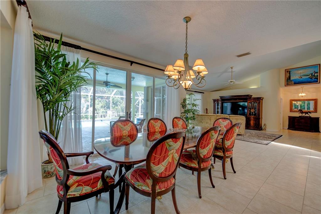 107 South Sewalls Point Road Stuart, FL 34996 - Photo 16 of 57 a dining room with furniture a chandelier and a rug