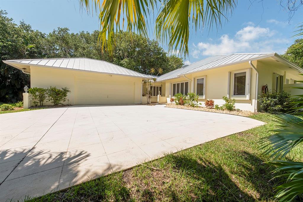 107 South Sewalls Point Road Stuart, FL 34996 - Photo 2 of 57 a front view of house along with road and trees