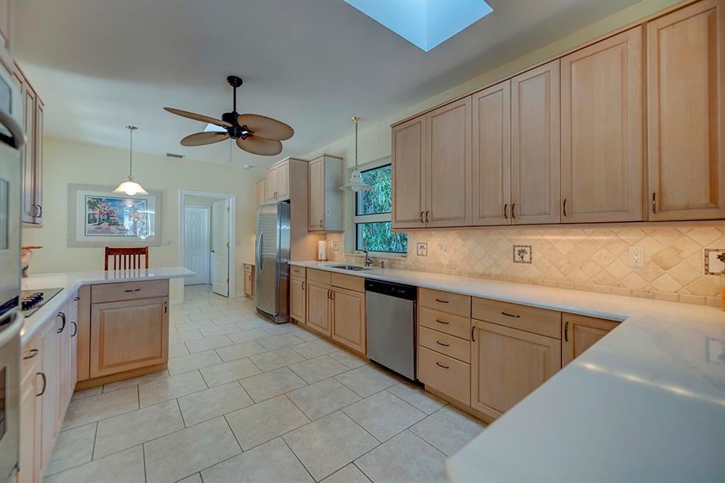 107 South Sewalls Point Road Stuart, FL 34996 - Photo 24 of 57 a kitchen with kitchen island granite countertop a sink counter top space appliances and cabinets