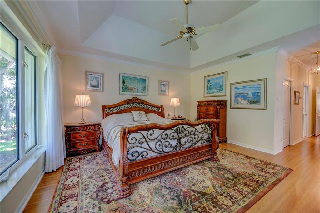 107 South Sewalls Point Road Stuart, FL 34996 - Photo 33 of 57 a bedroom with a bed and wooden floor