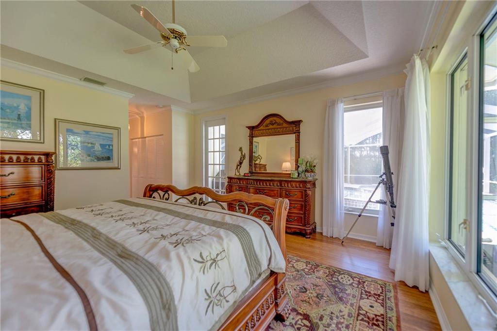 107 South Sewalls Point Road Stuart, FL 34996 - Photo 34 of 57 a bedroom with a bed and a dresser next to a window