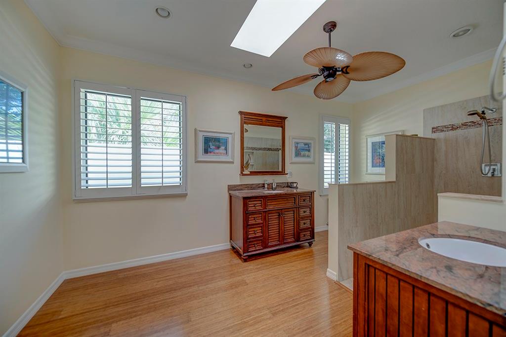 107 South Sewalls Point Road Stuart, FL 34996 - Photo 35 of 57 a room with a stove two couches and a flat screen tv with kitchen view