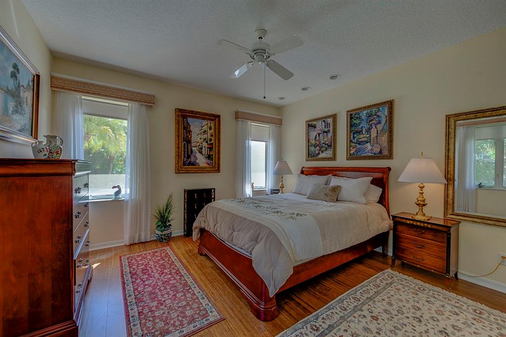 107 South Sewalls Point Road Stuart, FL 34996 - Photo 39 of 57 a bedroom with a bed and a lamp on dresser