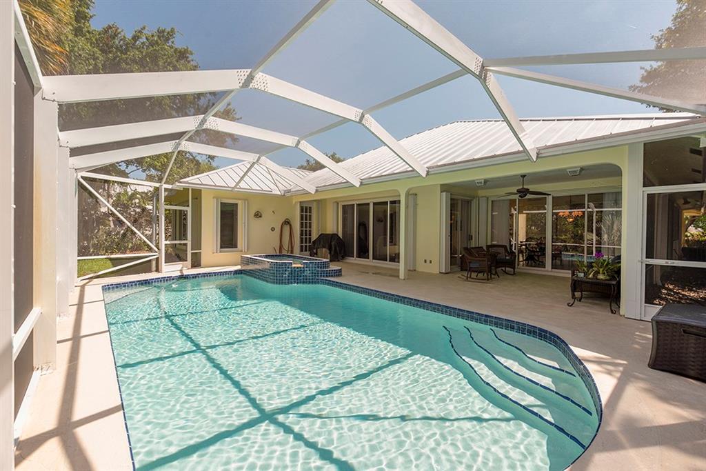 107 South Sewalls Point Road Stuart, FL 34996 - Photo 54 of 57 a view of a patio with table and chairs under an umbrella next to a yard
